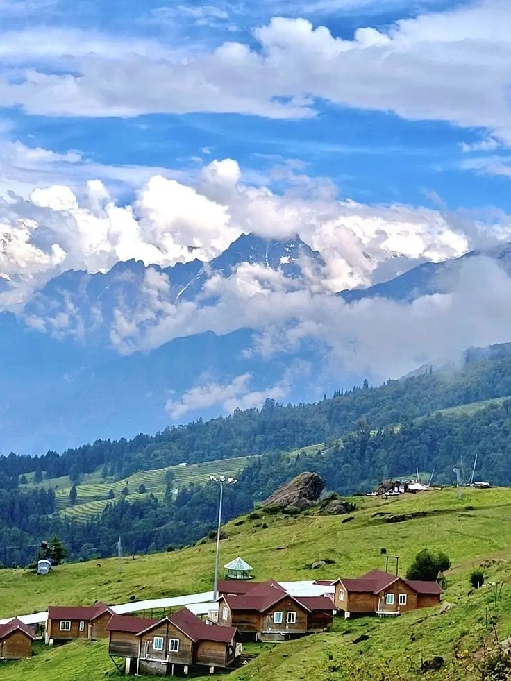 Snow-covered peaks and village above Auli, Uttarakhand