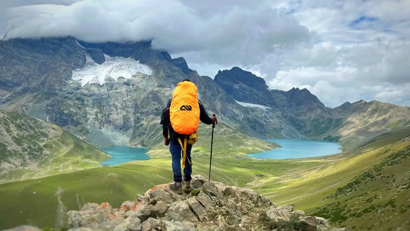 Hiker with a rucksack overlooking a mountain lake
