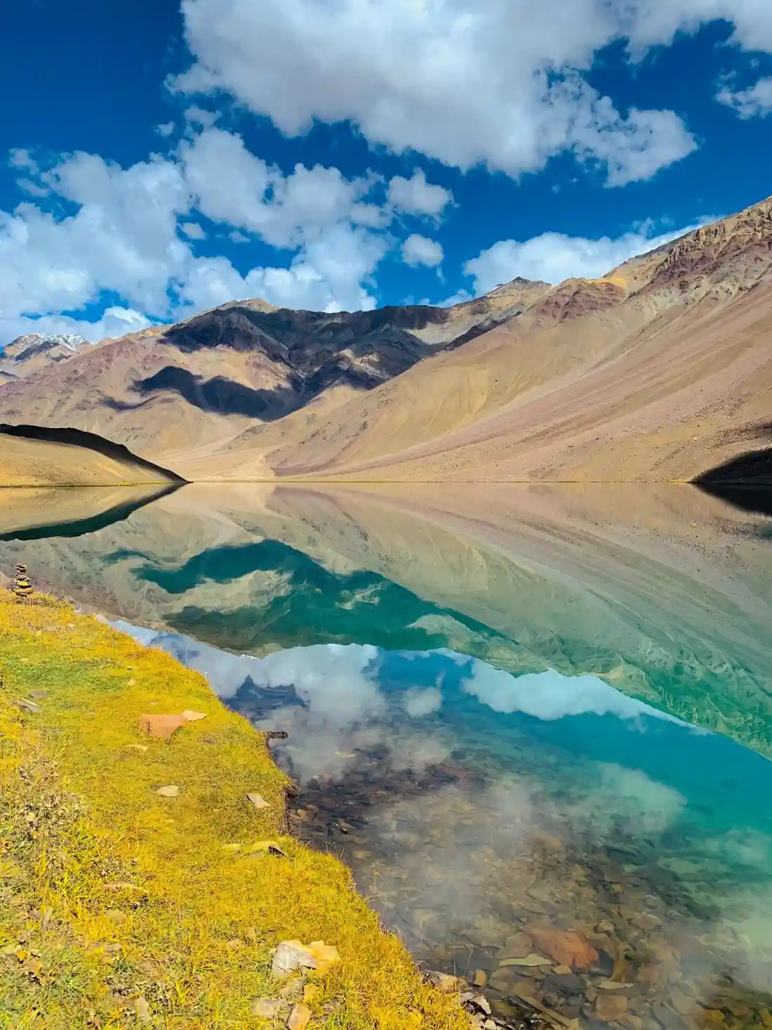 Frozen Chandratal lake surrounded by snow-covered mountains
