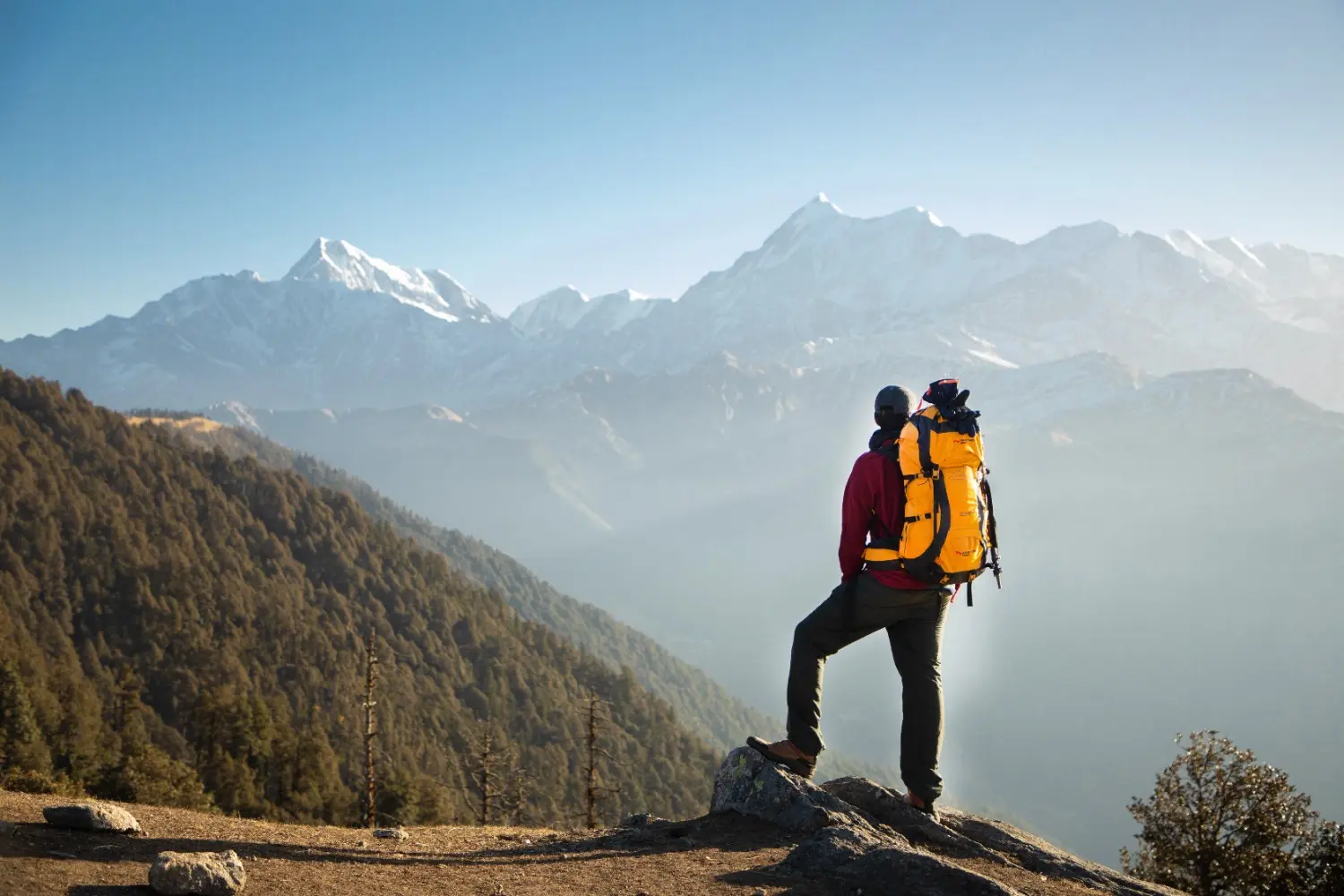 Mountaineer overlooking snow-capped peaks