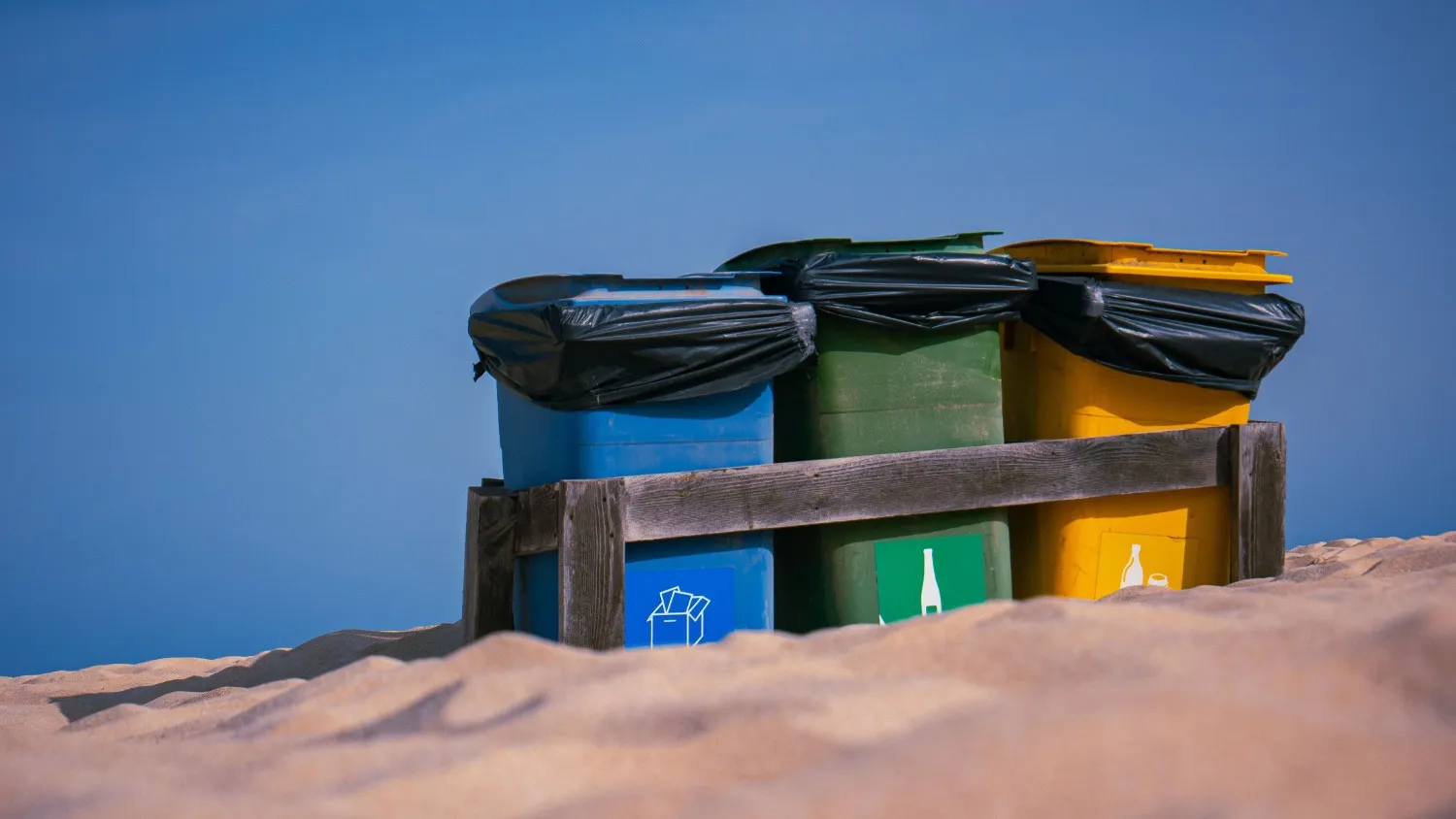 Recycling and waste bins at a trailhead campsite